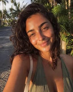 Traveler smiling in a tropical outdoor setting